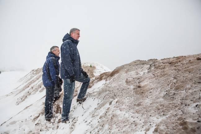 Mayor Bill de Blasio stands with the director of the Mayor's Office of Recovery and Resiliency, Daniel Zarrilli, on a temporary sand berm which built to protect against storm surge flooding on the beach at Coney Island during a major snowstorm in January 2016. Photo: Michael Appleton/Mayoral Photography Office