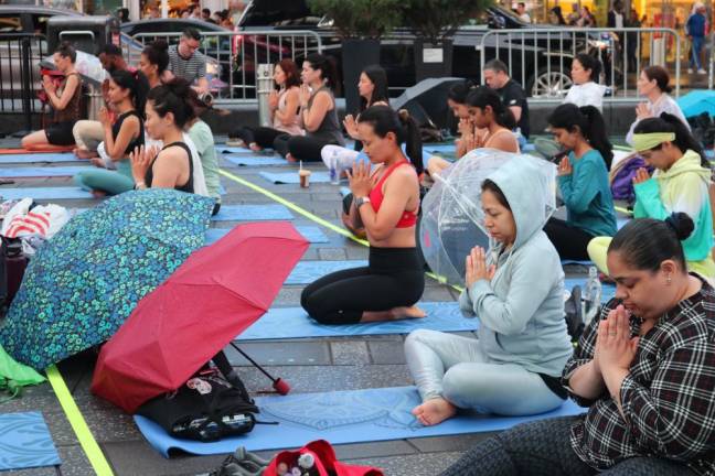 The Broadway pedestrian plazas were still filled with yoga mats as light rain cooled the solstice evening. Photo: Zoey Lyttle
