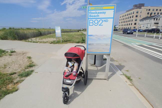 A child in a running stroller at Beach 92nd Street, Rockaway Beach.