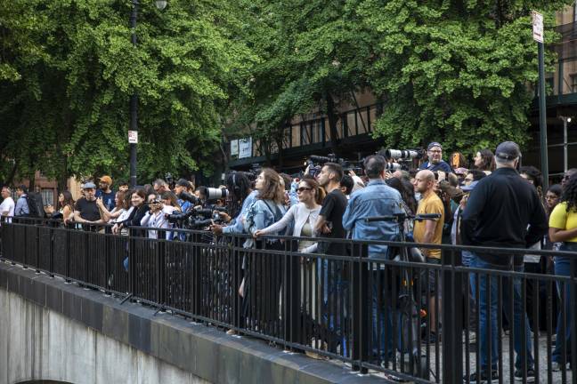 Crowd of people gathered at Tudor City Bridge, waiting for the sunset.