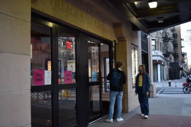 A couple walks into the Village East theater in the late afternoon on March 12. Photo: Leah Foreman