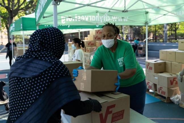 At a City Harvest Mobile Market, giving out food to the community. Photo: Jared Siskin