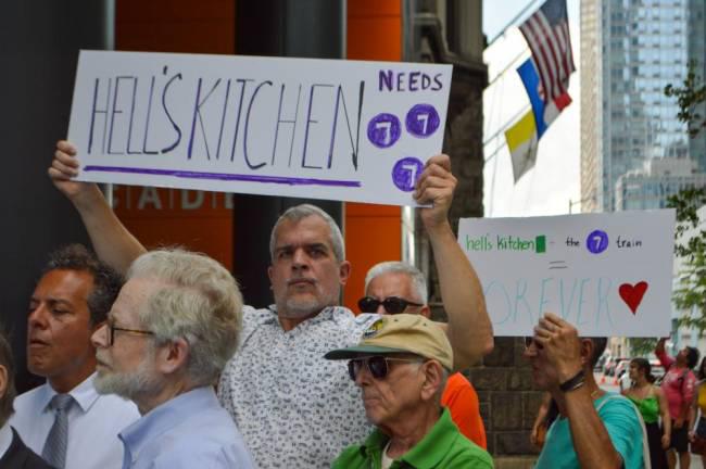 Signs at an August rally in support of a new Hell’s Kitchen #7 train. Photo: Abigail Gruskin