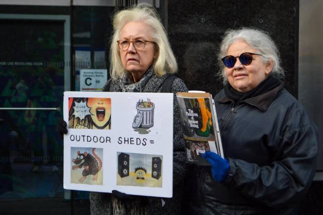 Protesters held handmade signs and copies of magazines for which outdoor dining stories made the cover. Photo: Abigail Gruskin