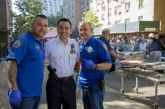 Captain Timothy E. Wong, commanding officer of the 10th Precinct, with other police officers at the National Night Out Against Crime in Chelsea on Aug. 4 at the NYCHA operated Fulton Houses.