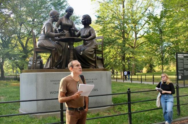 Author Aaron Poochigian before the Women Pioneers statue in Central Park.