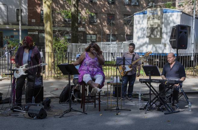 Lead singer Emilie Surtees and members of the Stage Revolution Band entertained attendees at the National Night Out Against Crime in the 10th Precinct staged at the NYCHAF-operated Fulton Houses.