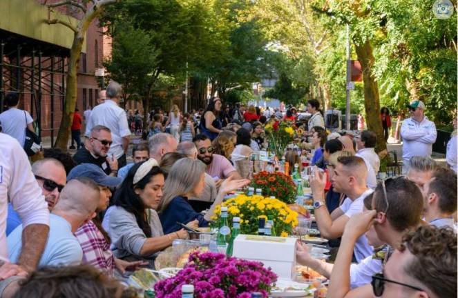 The “Longest Table in Chelsea” stretched nearly 550 feet down W. 21st, part of NYC’s Open Streets, between Ninth and Tenth Avenues. Photo: Mandy Ansari