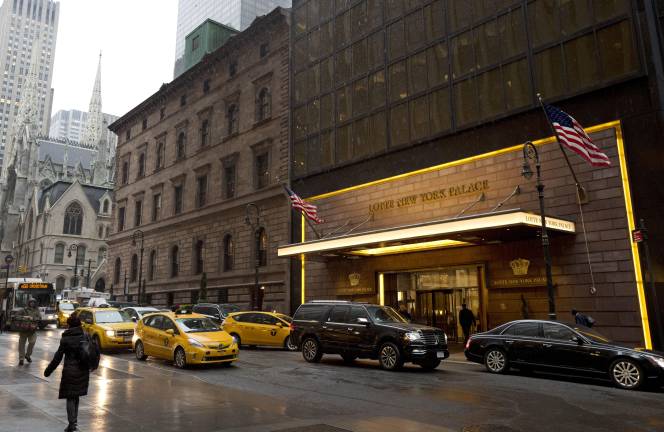 Traffic passes St. Patrick's Cathedral (far left) and the Lotte New York Palace Hotel. The Archdiocese of New York sold the land beneath the hotel for $490 million in Dec. 2025, a portion of which is going to a $300 million fund the Archdiocese established to pay for past victims of sexual abuse