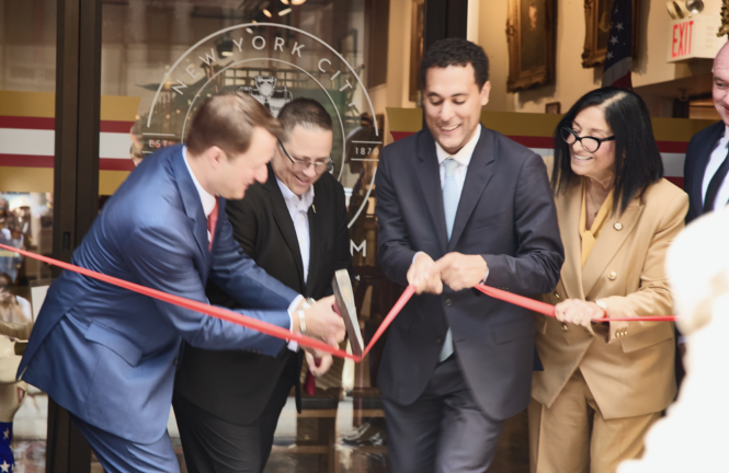 (From left) Fire Museum Executive Director Dominick DeRubbio and FDNY Commissioner Lillian Bonsignore use an FDNY ax to cut the reopening ribbon held by Council members Christopher Marte and Joann Ariola.