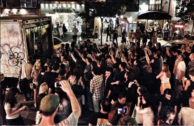 The crowd surrounding Banksy's roving mobile waterfall, which appeared in the back of a delivery truck in the East Village on Oct. 5, 2013. Courtesy of HBO