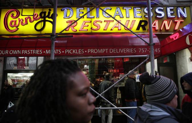 People waited on long line to eat at the Carnegie Delicatessen on Dec. 29, 2016 as it served up it last serving of cured meat before shutting down a decade ago. Now it is coming back only a few doors down from its original location.