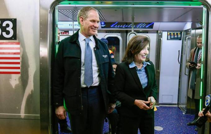 At the inauguration of the systems newest subway cars MTA CEO Janno Lieber and Gov. Kathy Hochul greet passengers at one of the door openings. The trains will run on the C line local tracks. The green LED lights display the door’s “open” status. Photo: MTA