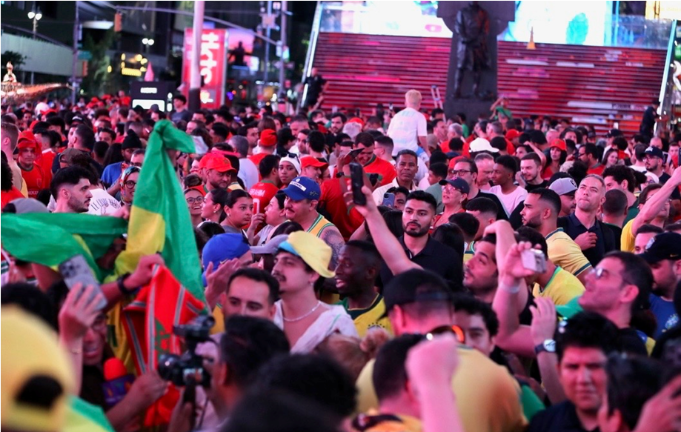 Futbol fans piled into Times Square on Friday, June 12 to watch FIFA World Cup games where the USA Men’s National Team beat Paraguay 4 to 1.