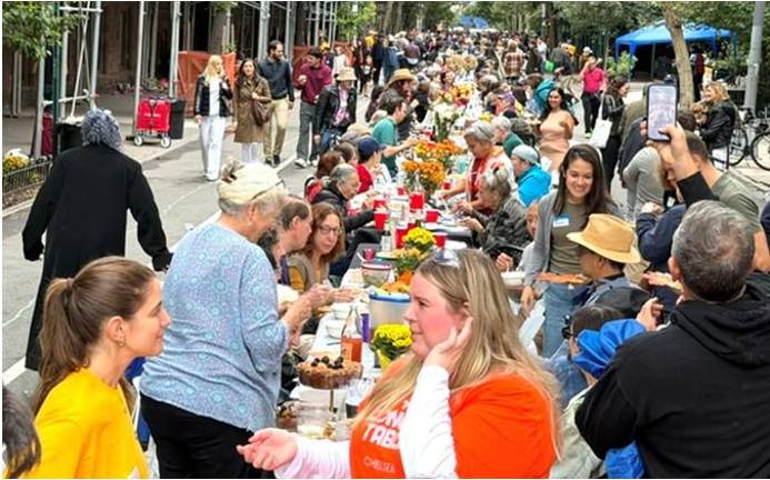 Meeting and greeting is a big part of the Longest Table in Chelsea, now in its fourth year. This year, a record setting 2,000 people turned out.