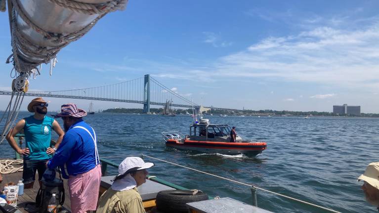 The U.S. Coast Guard approaching the Clearwater sloop. Officials said, “Turn your vessel back towards the bridge.”