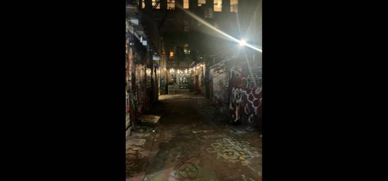 The ominous Freeman Alley at night seems to harken back to its coffin-maker roots.