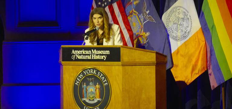 New York City Council Speaker Julie Menin speaking at State Senator Erik Bottcher’s inauguration ceremony at the AMNH.