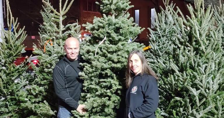 Heather Neville (right) at her popular Christmas Tree stand at Greenwich Ave. and Seventh Ave. is sometimes assisted by her husband Dave. She’s been running her own stand for 15 years and now has seven locations across the city. Photo: Courtesy of Heather Neville