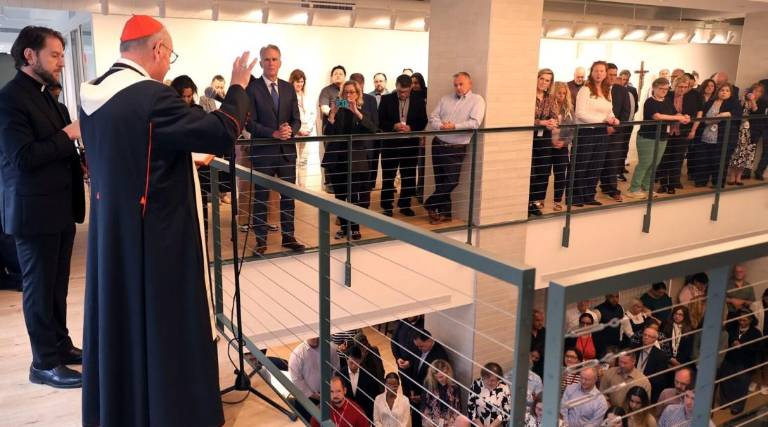Cardinal Timothy Dolan blesses the new HQ of the Catholic Archdiocese of New York at 488 Madison Ave. in June. The former HQ at 1011 First Ave. was sold to a developer who is planning an office-to-residential conversion, with 25 percent of its 420 units pledged to affordable housing.