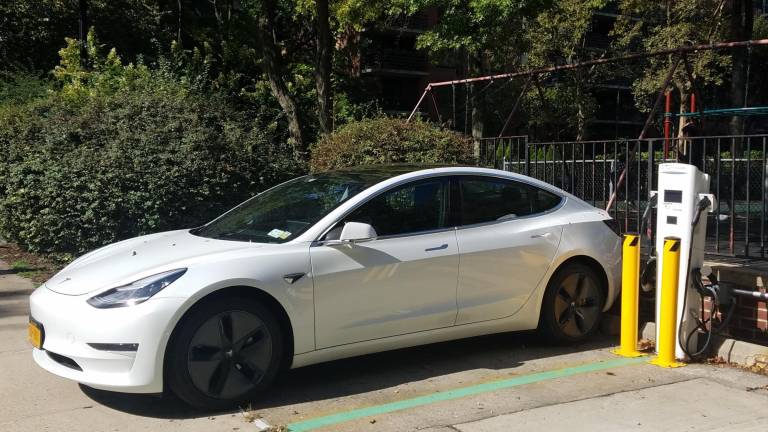 An outdoor electric vehicle charging station juices up a Tesla at 372 Central Park West, on the grounds of the Vaux Condominium in Park West Village. The number of chargers in public garages and on private property has mushroomed in recent years.