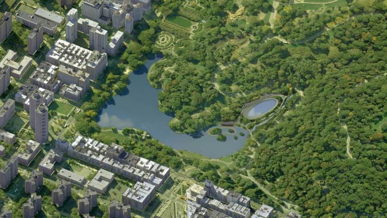 An aerial view of the reinvented north end of Central Park with Fifth Avenue at left and Central Park North at bottom. The Harlem Meer is at center, a circular boardwalk can be seen at the right-hand side of the Meer and the new oval-shaped Lasker pool and skating rink is at center-right.