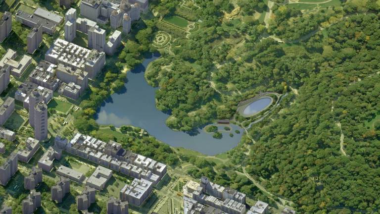 An aerial view of the reinvented north end of Central Park with Fifth Avenue at left and Central Park North at bottom. The Harlem Meer is at center, a circular boardwalk can be seen at the right-hand side of the Meer and the new oval-shaped Lasker pool and skating rink is at center-right.