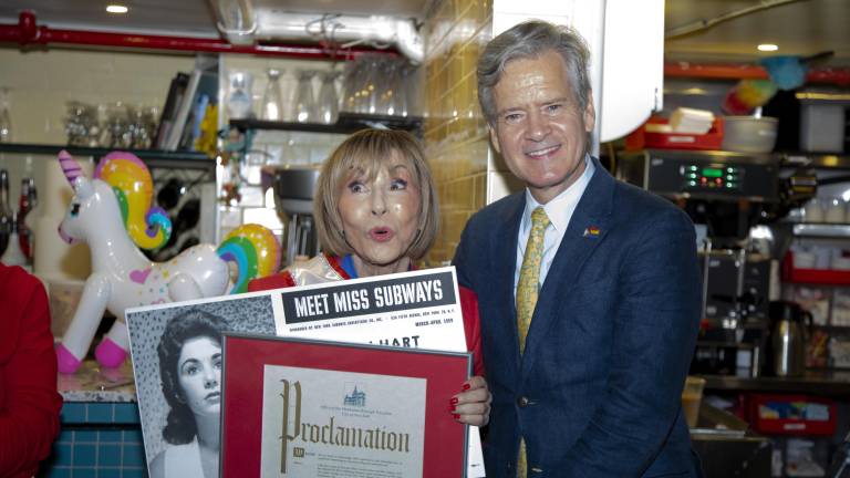 Ellen Hart, owner of Ellen’s Stardust Diner and a former Miss Subways (1959), poses with Manhattan Borough President Brad Hoylman-Sigal holding her original Miss Subways poster and a Proclamation in celebration of the Miss Subways reunion and her 85th birthday.