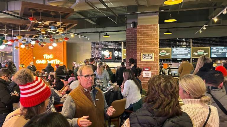 Co-owner Phil Colicchio (center, brown vest) is behind Central Perk, a new full-service cafe in Times Square that uses the name of the famous coffee shop in “Friends” under an agreement with Warner Bros.