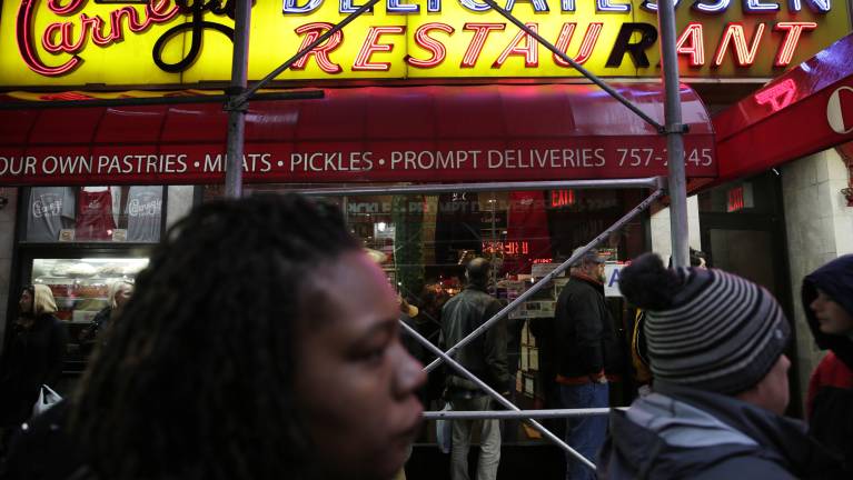 People waited on long line to eat at the Carnegie Delicatessen on Dec. 29, 2016 as it served up it last serving of cured meat before shutting down a decade ago. Now it is coming back only a few doors down from its original location.