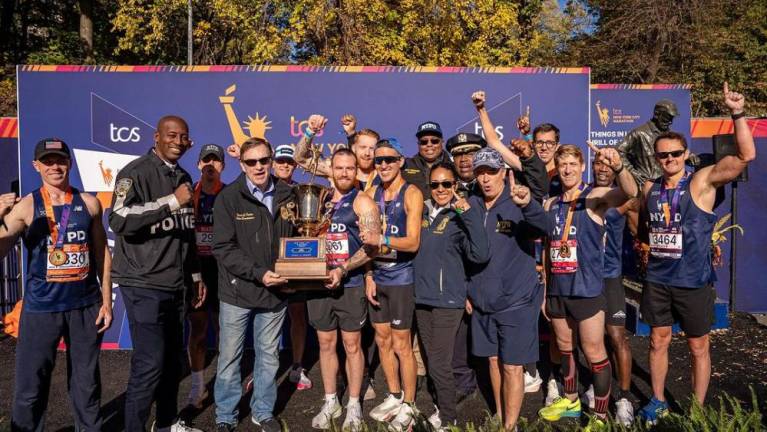 NYPD runners and brass with the Mayor’s Cup trophy. Recent combatants Tarik Shepherd (second from left) and Thomas Donlon (fourth from left) smile for the camera.
