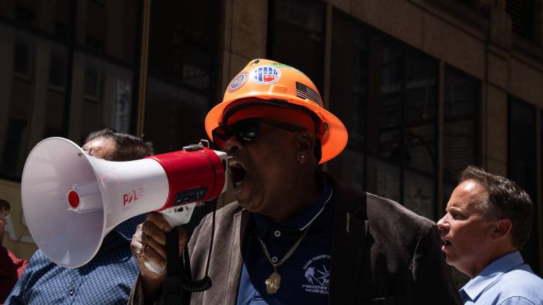 Anthony Williamson, Local 79 spokesperson, leading a chant on July 9, blasting the non-union developers behind the troubled building.