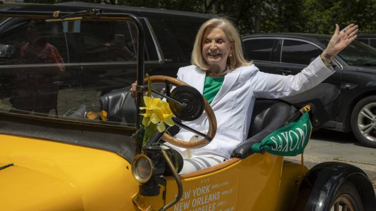 Former Representative Carolyn Maloney, the founder and CEO of ERA NOW, waves from the Golden Flyer II.