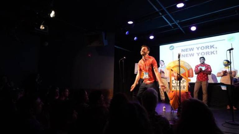 Nikolai Vanyo at the mic during the monthly pub fest, Punderdome. Photo: Punderdome