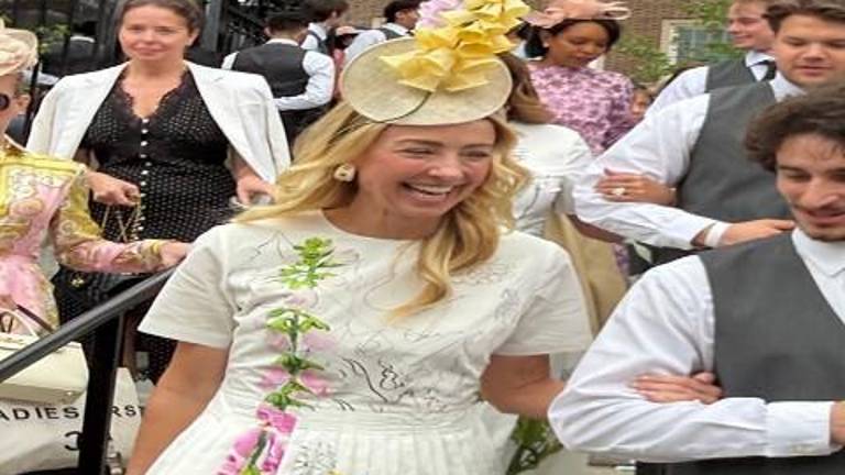 Jewelry designer to the stars Blair Husain shares a laugh as she is escorted into the Hat Show in the Conservancy Garden in Central Park.