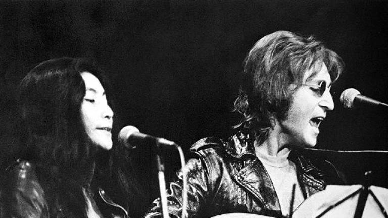 John Lennon and Yoko Ono, seen here performing at the Sinclair Freedom Rally in December 1971, had just released the “Double Fantasy” album in 1980 shortly before Lennon was murdered outside the Dakota apartment building where they lived. Photo: University of Michigan/Wikimedia Commons