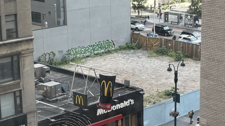 A view overlooking the vacant lot located at the northeast corner of 8th Avenue and 34th Street, on which Vornado plans to build a 38-story mixed-use tower, incorporating the existing entrance to 34th Street–Penn Station into the tower’s ground floor.