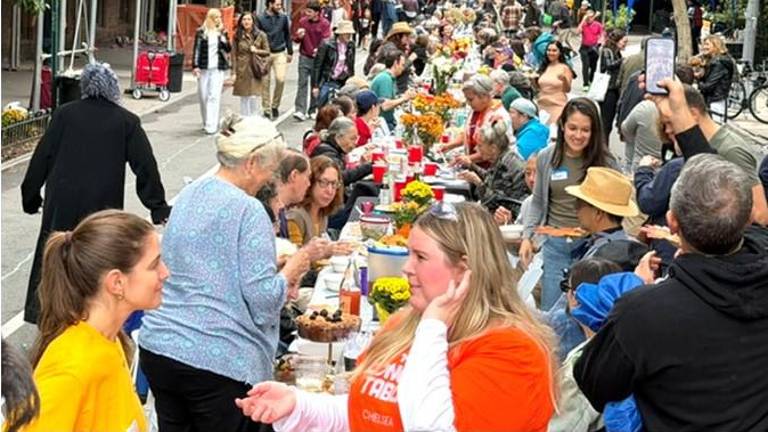 Meeting and greeting is a big part of the Longest Table in Chelsea, now in its fourth year. This year, a record setting 2,000 people turned out.