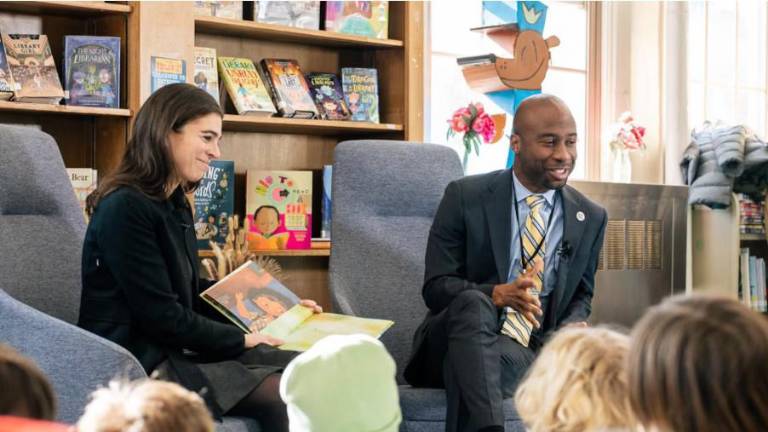 Schools Chancellor Kamar Samuels and Emmy Liss, executive director of the mayor’s Office of Child Care, read to students on Feb. 4. Samuels is planning to visit all five boroughs to hear from families and educators. (Courtesy of New York City Public Schools Press Office)