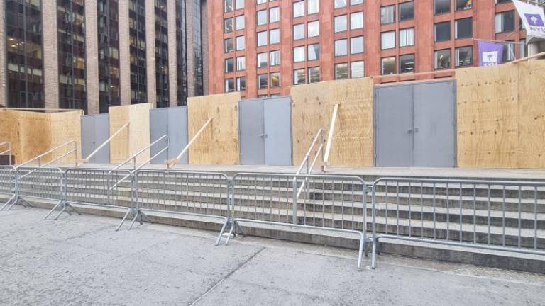 NYU has built a wooden wall around the protest site as a response.